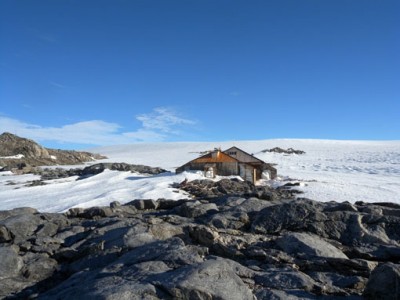 Antarctica's vast ice plateau looms behind Douglas Mawson's 1912 expedition headquarters.