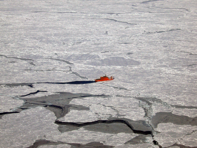 Australia’s icebreaker <em>Aurora Australis</em> “parked” against an ice flow during sea-ice coring and surveying off the Antarctic coast south of Australia. PHOTO JAN LIESER