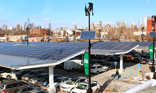 A “solar carport” at a whole foods business in Brooklyn, USA, featuring electric vehicle chargers, wind turbines and solar panels. PHOTO: Urban Green Energy/Ecowatch