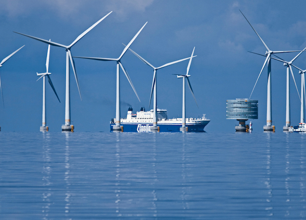 A freighter passes through the Swedish Lillgrund wind farm, an average-sized 110-megawatt offshore facility in the Baltic Sea. Since 2008 the farm’s 48 turbines have provided enough power for 60,000 households. The circular substation houses an offshore transformer which bundles the power from the turbines for dispatch to the national grid. PHOTO Siemens