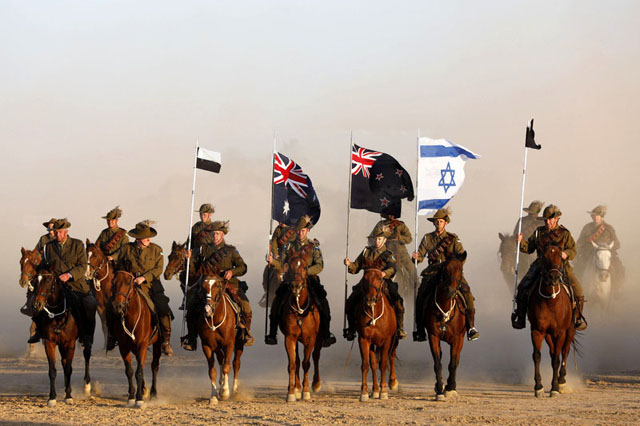 The Israeli flag flies alongside those of Australia and New Zealand in the re-enacted advance on Beersheba on 31 October. PHOTO Abir Sultan, European Pressphoto Agency